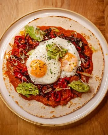 Huevos rancheros at Pori: fried eggs, roasted red pepper and smashed avocado on a tortilla
